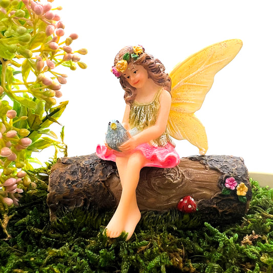 Fairy Anna Fairy Garden figurine with a bird sitting on a log