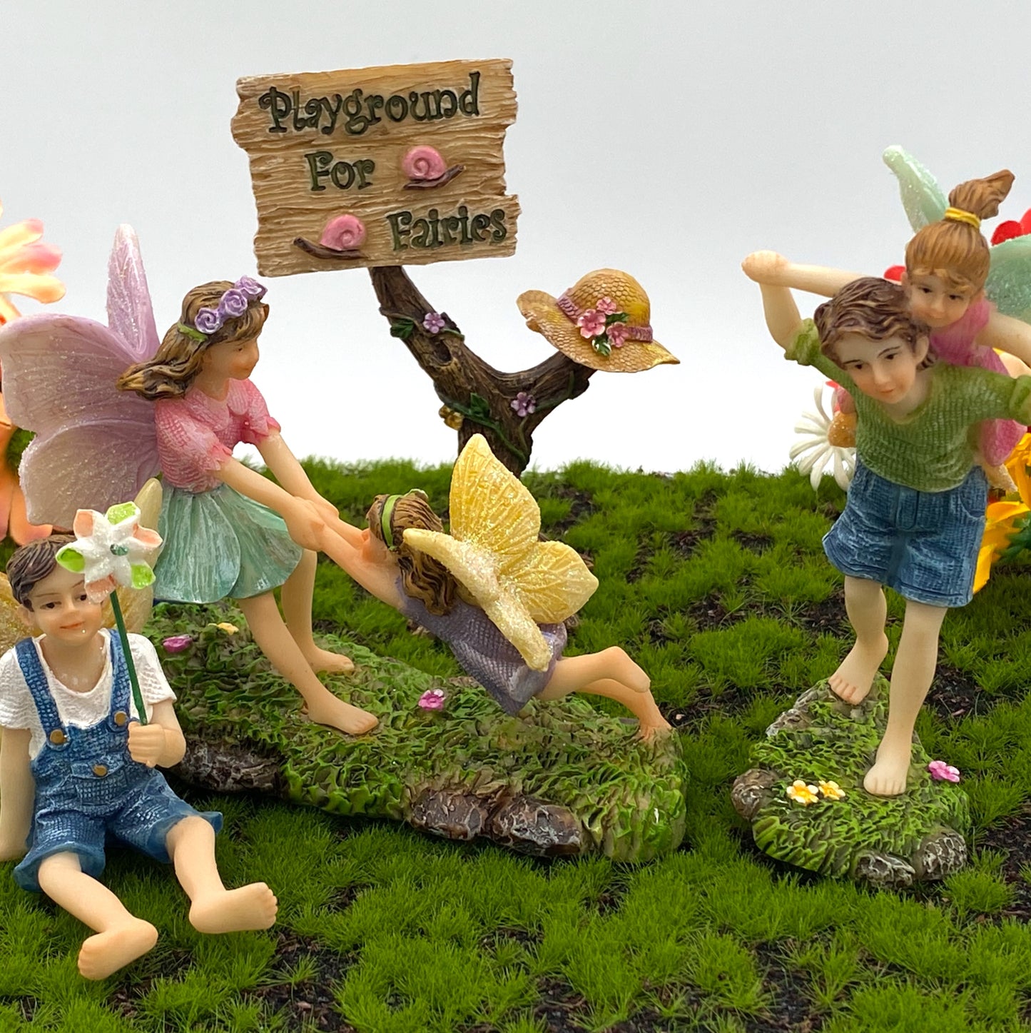 A group of five miniature fairies playing together.